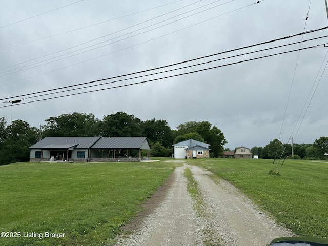 9115 Independence School Rd, Louisville, KY 40228 - view of front of property with a front yard, dirt driveway, a metal roof, and an outbuilding