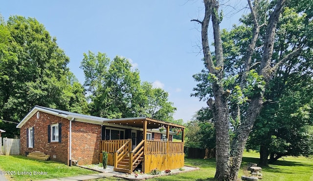 94 Buckhorn Ln, Leitchfield, KY 42754 - view of front of home featuring brick siding, a wooden deck, and stairs