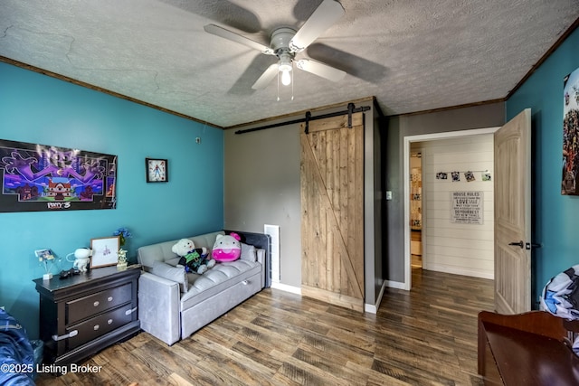 94 Buckhorn Ln, Leitchfield, KY 42754 - bedroom with a barn door, wood finished floors, a textured ceiling, ornamental molding, and ceiling fan