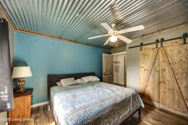 94 Buckhorn Ln, Leitchfield, KY 42754 - bedroom with wood finished floors, a ceiling fan, and a barn door