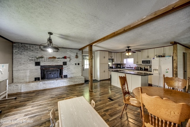 94 Buckhorn Ln, Leitchfield, KY 42754 - dining area with dark wood-style floors, a textured ceiling, and a ceiling fan