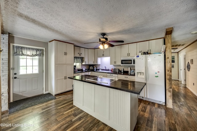 94 Buckhorn Ln, Leitchfield, KY 42754 - kitchen with white appliances, dark countertops, dark wood finished floors, a textured ceiling, and a center island