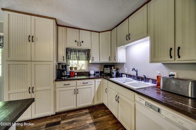 94 Buckhorn Ln, Leitchfield, KY 42754 - kitchen featuring white dishwasher, dark wood-style flooring, a textured ceiling, and cream cabinetry