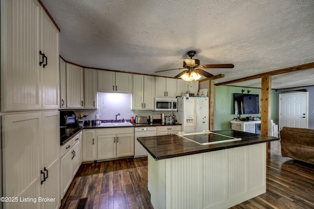 94 Buckhorn Ln, Leitchfield, KY 42754 - kitchen with white appliances, dark countertops, a textured ceiling, dark wood-style floors, and a center island