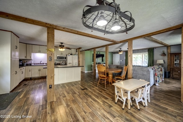 94 Buckhorn Ln, Leitchfield, KY 42754 - dining area featuring a textured ceiling, a ceiling fan, beam ceiling, and dark wood-type flooring