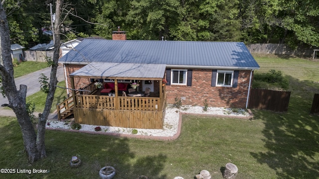 94 Buckhorn Ln, Leitchfield, KY 42754 - back of house featuring brick siding, a chimney, a metal roof, and a wooden deck