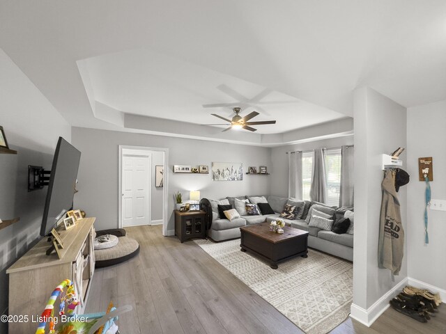 131 Benelli Dr, Bardstown, KY 40004 - living area with a raised ceiling, light wood finished floors, and ceiling fan