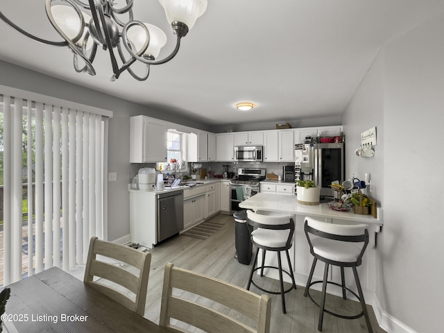 131 Benelli Dr, Bardstown, KY 40004 - kitchen featuring stainless steel appliances, light wood-style floors, light countertops, and white cabinetry