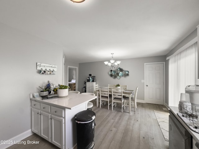 131 Benelli Dr, Bardstown, KY 40004 - kitchen with a chandelier, light wood-style flooring, light countertops, white cabinets, and pendant lighting