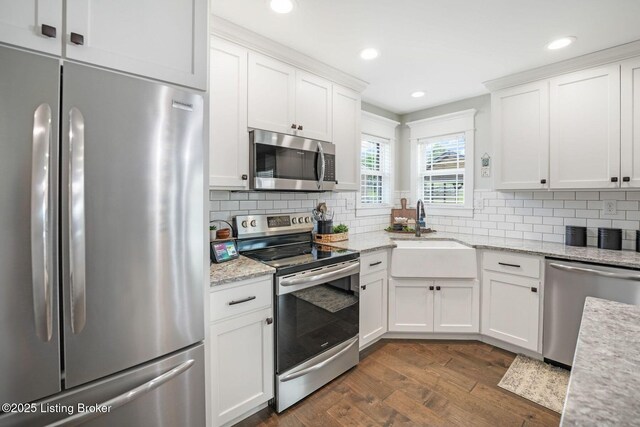 57 Pilots Way, Taylorsville, KY 40071 - kitchen featuring stainless steel appliances, dark wood-type flooring, white cabinets, tasteful backsplash, and light stone counters