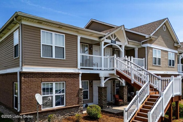 9003 Falcon Crest Ct Unit 104, Louisville, KY 40219 - view of front of home featuring stairs, covered porch, and brick siding