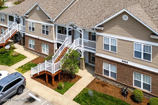 9003 Falcon Crest Ct Unit 104, Louisville, KY 40219 - view of property featuring stairs and uncovered parking