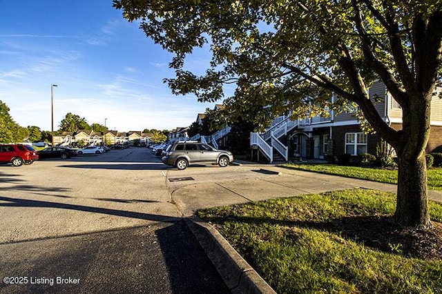 9003 Falcon Crest Ct Unit 104, Louisville, KY 40219 - view of road with stairway, street lights, and a residential view