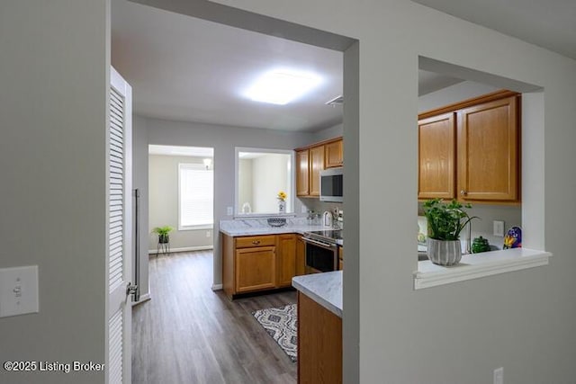 9003 Falcon Crest Ct Unit 104, Louisville, KY 40219 - kitchen featuring stainless steel appliances, dark wood-style floors, light countertops, and brown cabinetry