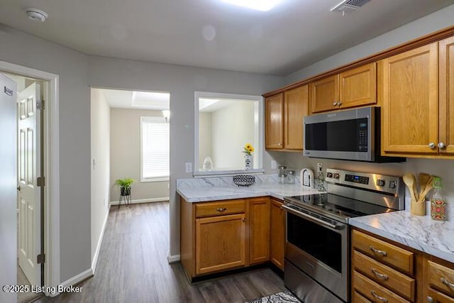 9003 Falcon Crest Ct Unit 104, Louisville, KY 40219 - kitchen with stainless steel appliances, dark wood finished floors, and brown cabinetry