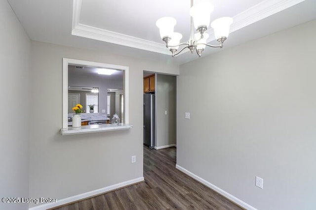9003 Falcon Crest Ct Unit 104, Louisville, KY 40219 - unfurnished dining area with dark wood-type flooring, a chandelier, crown molding, and a raised ceiling