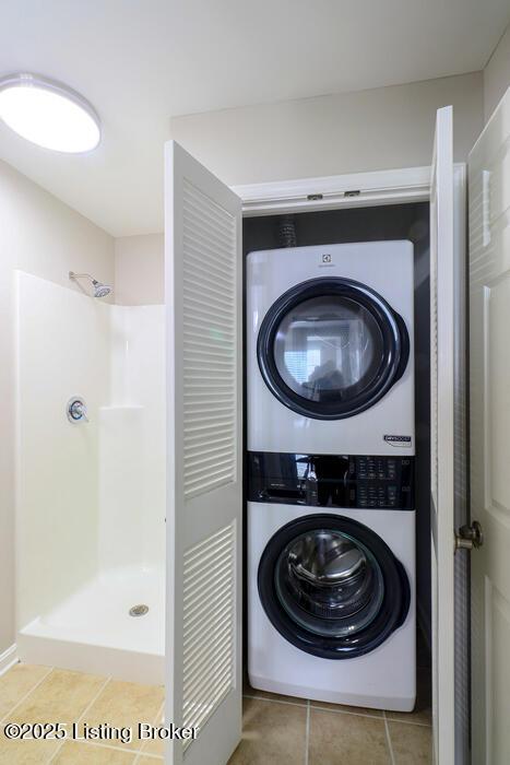 9003 Falcon Crest Ct Unit 104, Louisville, KY 40219 - laundry area with stacked washer / drying machine and tile patterned floors