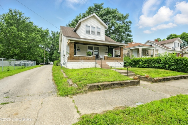 2618 S 5th St, Louisville, KY 40208 - bungalow-style house with a porch, driveway, and brick siding