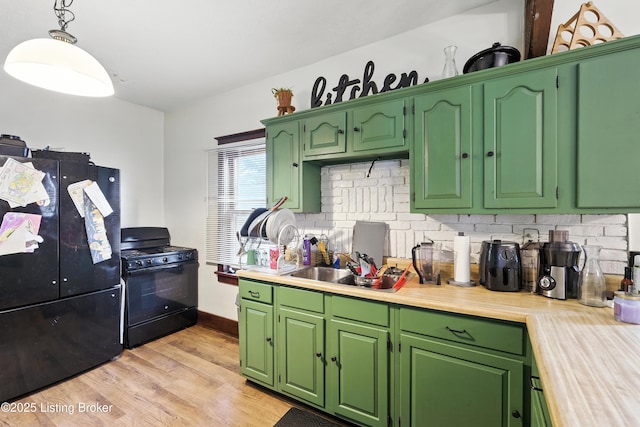2618 S 5th St, Louisville, KY 40208 - kitchen featuring black appliances, backsplash, light countertops, light wood-type flooring, and pendant lighting