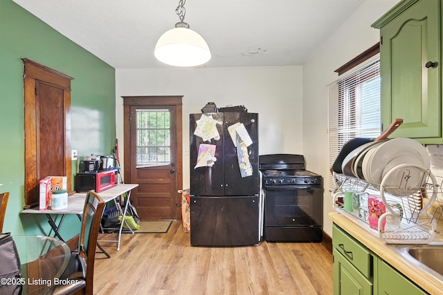 2618 S 5th St, Louisville, KY 40208 - kitchen with green cabinetry, black appliances, light wood finished floors, and plenty of natural light