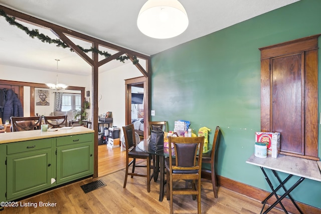 2618 S 5th St, Louisville, KY 40208 - dining space featuring a chandelier and light wood-style flooring