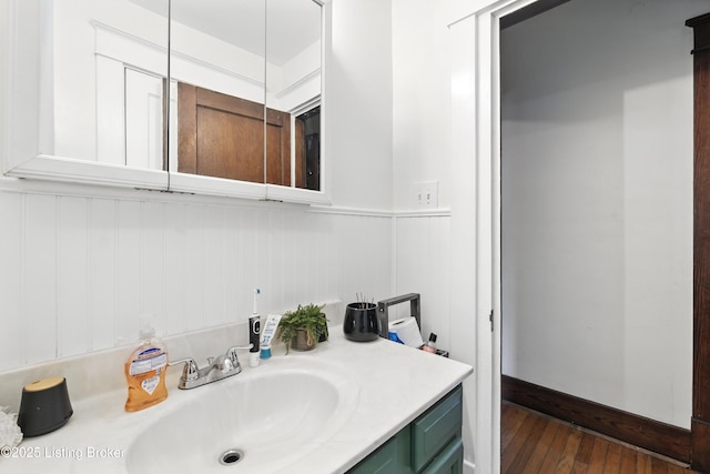2618 S 5th St, Louisville, KY 40208 - bathroom featuring vanity, hardwood / wood-style floors, and wainscoting
