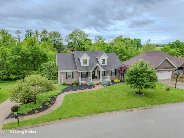 116 N Howard St, Bardstown, KY 40004 - new england style home with covered porch, brick siding, a front lawn, driveway, and an attached garage