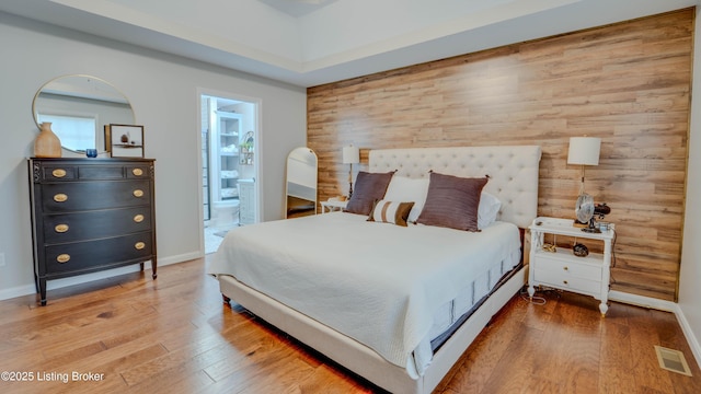 116 N Howard St, Bardstown, KY 40004 - bedroom with wood finished floors, ensuite bath, and wood walls