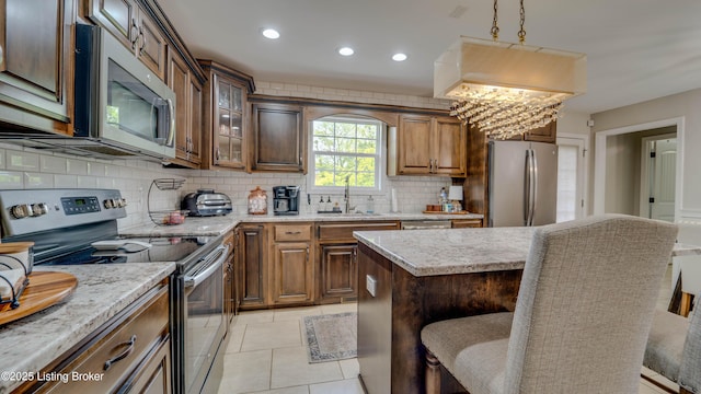 116 N Howard St, Bardstown, KY 40004 - kitchen with stainless steel appliances, a breakfast bar area, backsplash, recessed lighting, and light tile patterned flooring