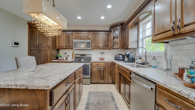 116 N Howard St, Bardstown, KY 40004 - kitchen featuring stainless steel appliances, tasteful backsplash, light stone countertops, and recessed lighting