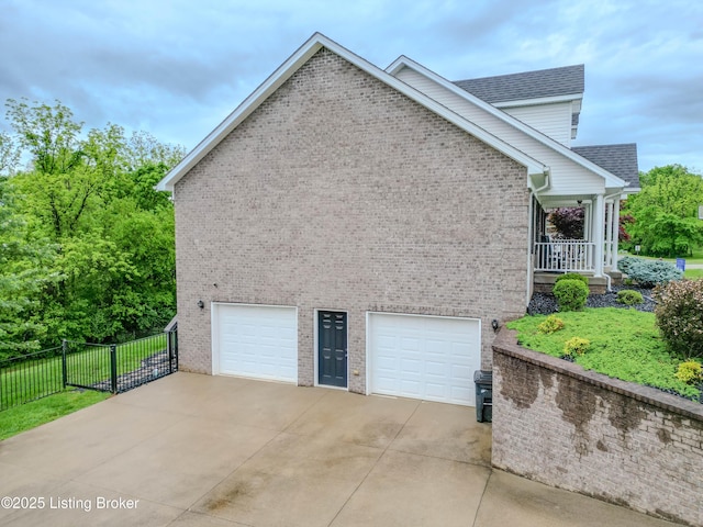 116 N Howard St, Bardstown, KY 40004 - view of property exterior featuring an attached garage, brick siding, concrete driveway, and roof with shingles