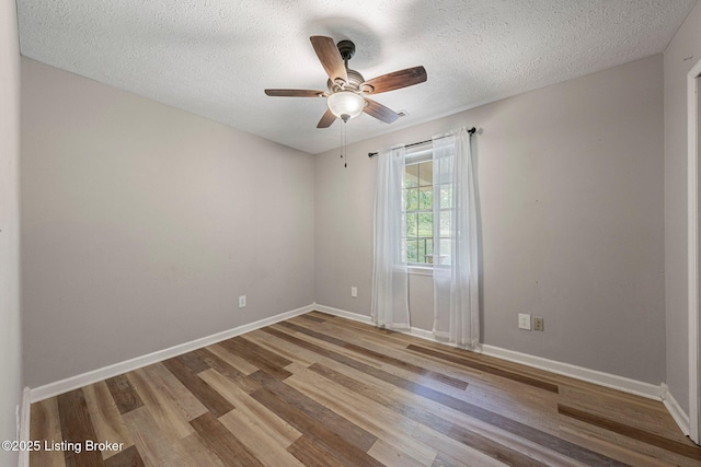 606 Lone Oak Rd, Clarkson, KY 42726 - spare room with wood finished floors, ceiling fan, and a textured ceiling