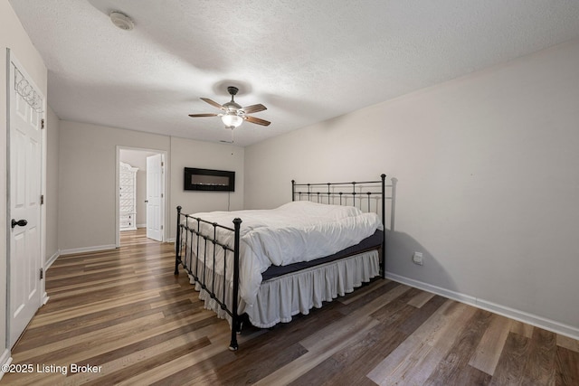 606 Lone Oak Rd, Clarkson, KY 42726 - bedroom featuring wood finished floors, a textured ceiling, and a ceiling fan