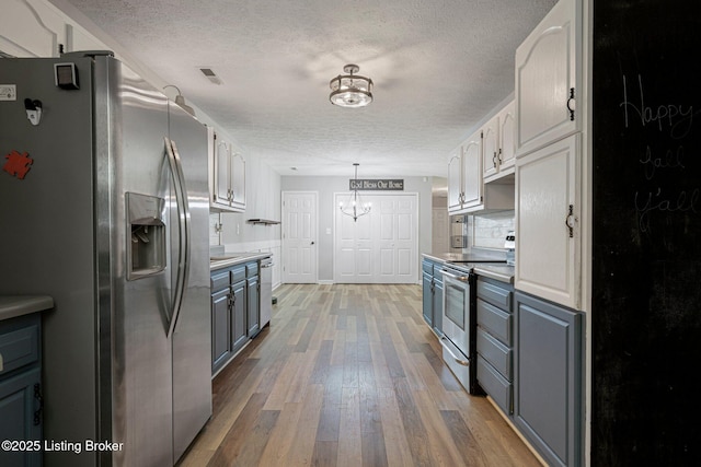606 Lone Oak Rd, Clarkson, KY 42726 - kitchen with appliances with stainless steel finishes, a textured ceiling, a chandelier, gray cabinetry, and wood-type flooring
