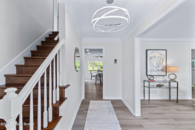 5515 Hempstead Rd, Louisville, KY 40207 - entryway with a chandelier, wood finished floors, stairway, and ornamental molding