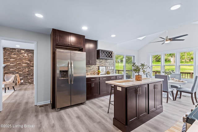 5515 Hempstead Rd, Louisville, KY 40207 - kitchen featuring stainless steel fridge, light countertops, a ceiling fan, dark brown cabinets, and vaulted ceiling