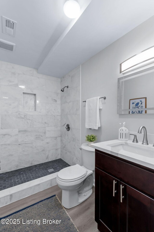 5515 Hempstead Rd, Louisville, KY 40207 - bathroom featuring vanity, a tile shower, and wood finished floors