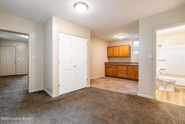 2113 Willow St, New Albany, IN 47150 - kitchen with light colored carpet and brown cabinets