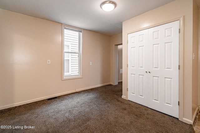 2113 Willow St, New Albany, IN 47150 - unfurnished bedroom with dark carpet and a closet