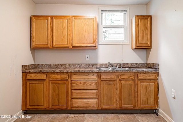 2113 Willow St, New Albany, IN 47150 - kitchen featuring dark countertops and brown cabinetry