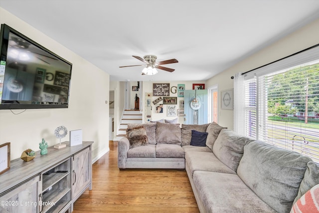 3408 Acacia Ave, Shepherdsville, KY 40165 - living room featuring ceiling fan, light wood-style flooring, and stairway