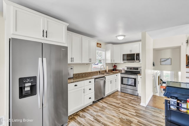 3408 Acacia Ave, Shepherdsville, KY 40165 - kitchen with appliances with stainless steel finishes, white cabinets, light wood finished floors, and dark stone countertops