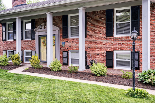 7401 Switch Bark Rd, Louisville, KY 40228 - doorway to property featuring a chimney, brick siding, a porch, and a yard