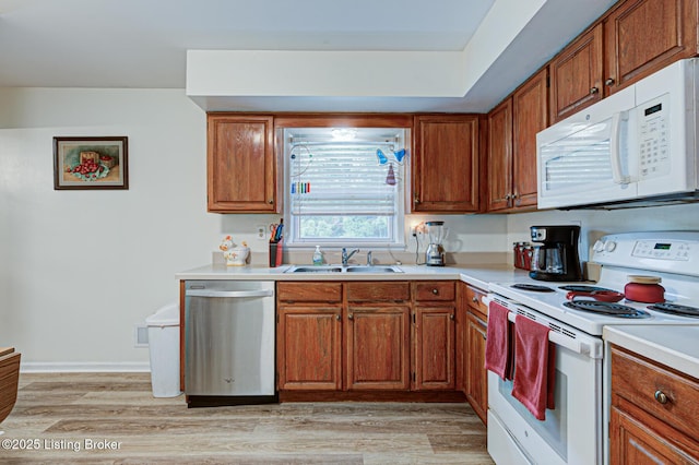 7401 Switch Bark Rd, Louisville, KY 40228 - kitchen featuring white appliances, light countertops, light wood-style floors, and brown cabinets