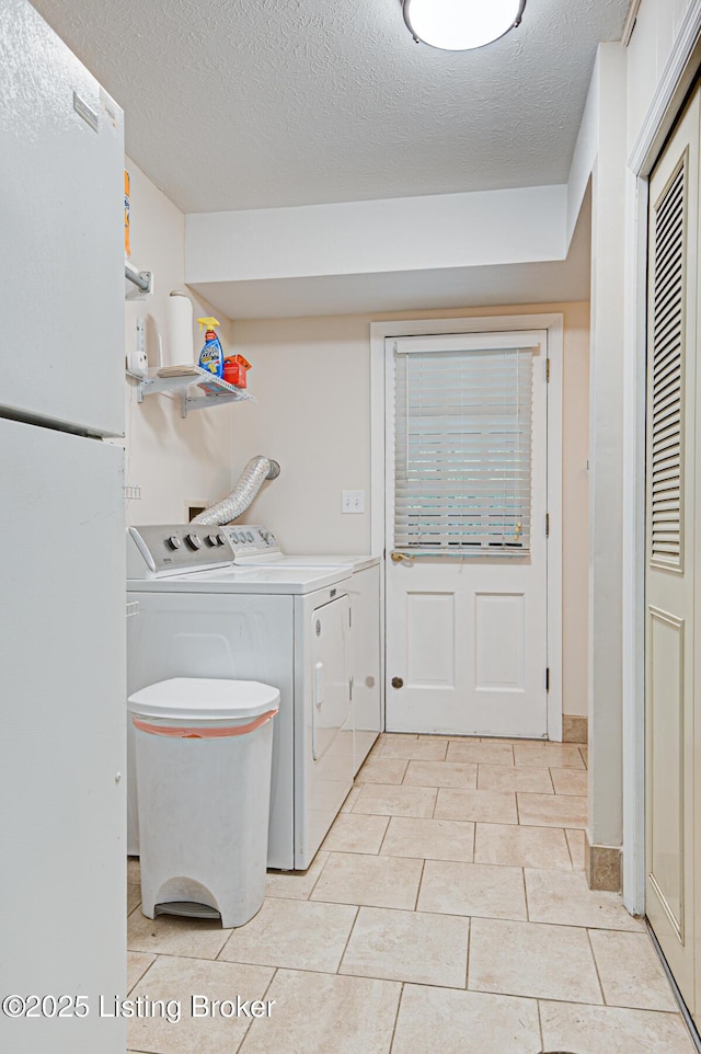 7401 Switch Bark Rd, Louisville, KY 40228 - laundry area featuring separate washer and dryer, a textured ceiling, and light tile patterned floors