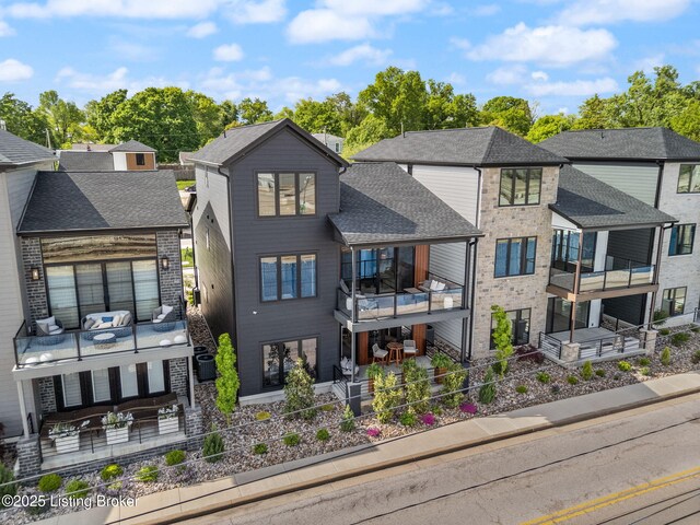 104 Howard Ln, Jeffersonville, IN 47130 - rear view of property with a balcony, an outdoor hangout area, a patio, and brick siding