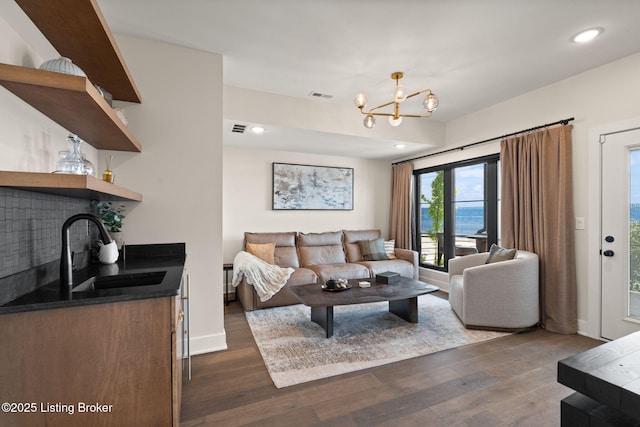 104 Howard Ln, Jeffersonville, IN 47130 - living area featuring dark wood-style floors, a chandelier, recessed lighting, and bar