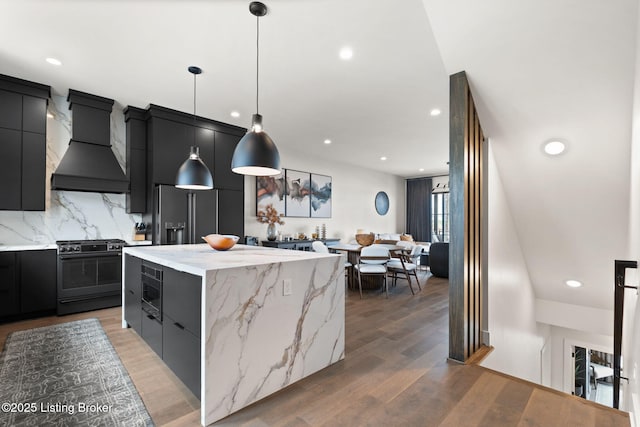104 Howard Ln, Jeffersonville, IN 47130 - kitchen featuring stainless steel range with gas cooktop, custom exhaust hood, refrigerator with ice dispenser, dark cabinets, and a center island