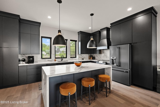 104 Howard Ln, Jeffersonville, IN 47130 - kitchen with high quality fridge, light wood-style flooring, backsplash, a breakfast bar, and pendant lighting