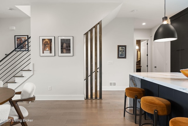 104 Howard Ln, Jeffersonville, IN 47130 - bar area with wood finished floors, recessed lighting, stairway, and hanging light fixtures